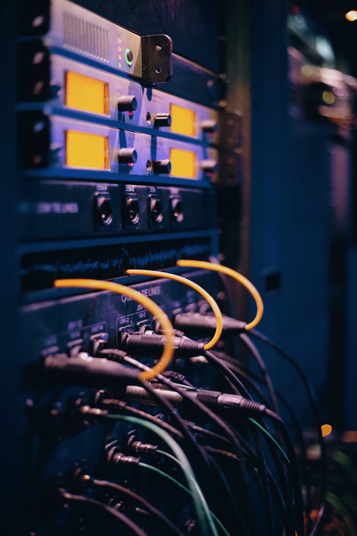 why-choose-us Close-up of network cables and ports in a server rack, showcasing connectivity.